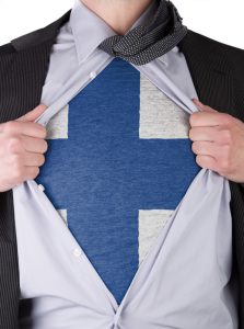 Business man rips open his shirt to show his Finnish flag t-shirt